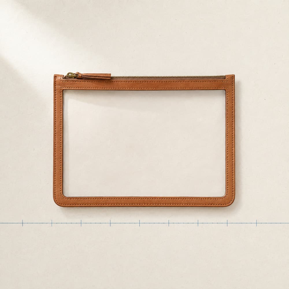 Clear-Pouch Companion — A leather frame around a transparent window. Dimensions stated, nothing promised.